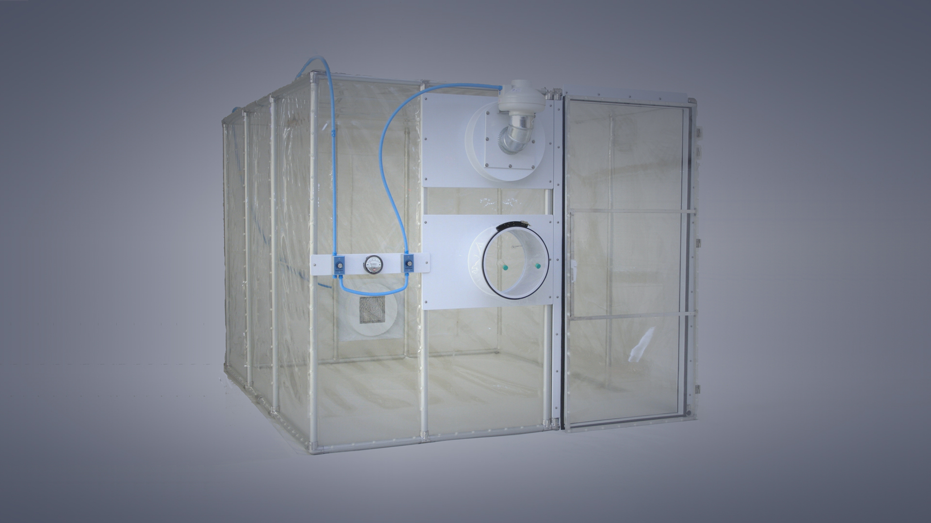 Pictured is a negative pressure, flexible film (softwall) containment unit that is designed to be a necropsy room, with enough space for a necropsy table, waterline, discharge collection and pass in/out transfer port (restricted access barrier unit).