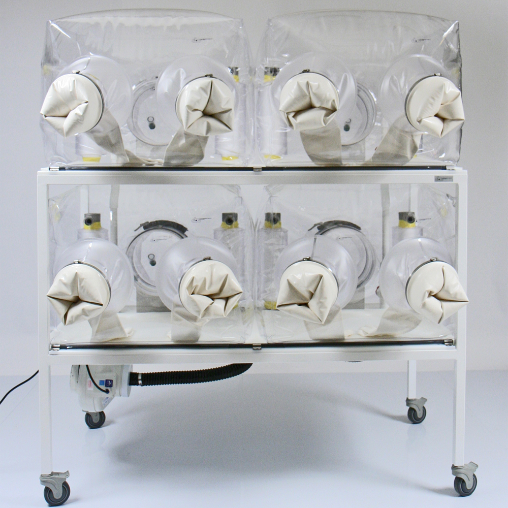 View of CBC Quad Isolator Systems for mice or other rodents with gloves on the side.