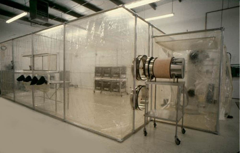 Positive Pressure, Flexible Film (Softwall) Cleanroom that is completely enclosed and is designed to provide a completely controlled production environment so chronic studies do not have to be started over due to contamination of control or test specimens. Note: The chamber is not a laminar airflow design but is completely enclosed.